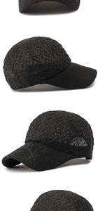 Detail of black mesh knit baseball cap with hollow diamond patterns and solid brim