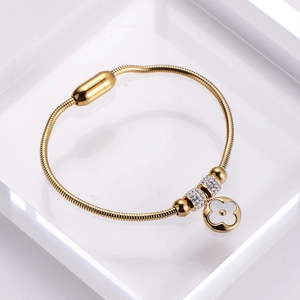 Gold-plated snake chain bracelet featuring a white clover pendant and zircon beads