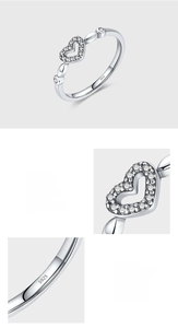 Macro detail of S925 sterling silver stamp and pave setting zircons on heart ring