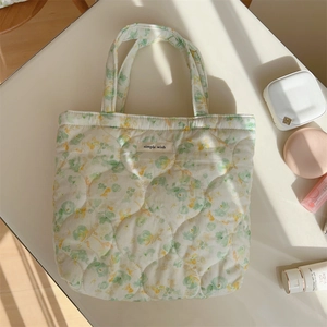 Detailed macro view of floral quilted tote fabric with a central simple wish label