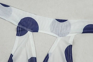 Detailed close-up of blue polka dot mesh fabric with high-quality stitching on shoulder strap
