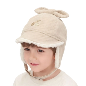 Close-up of beige corduroy kids winter hat with bow and cherry embroidery detail