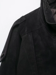 Close-up of shoulder epaulettes and stitching on black matte faux leather biker jacket
