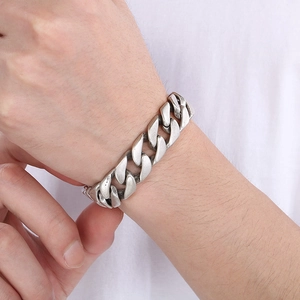 Detail of vintage silver Cuban link chain bracelet with oxidized finish on male wrist