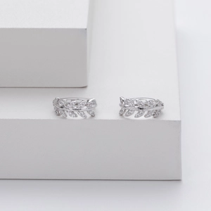 Detailed view of silver S925 sterling silver leaf hoop earrings with pavé zircon stones