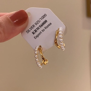 Detail showing 925 silver needle pearl double-layered C-shaped gold hoop earrings