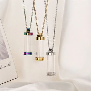 Detailed view of openable perfume bottle necklaces in rainbow, gold, and silver finishes