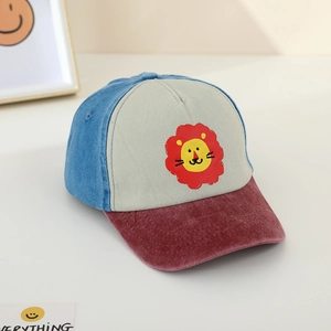 Detail shot of color-block kids baseball cap with cute cartoon lion print and velvet brim