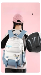 Detail of breathable honeycomb mesh shoulder straps on blue and white student backpack