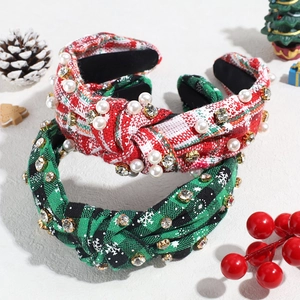 Detail of Christmas knot headbands with rhinestones and pearls on festive background