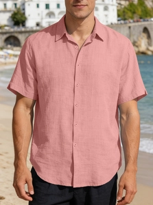 Close-up of pink linen-style short sleeve shirt showing fabric texture and button collar