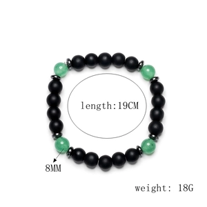 Detailed view of 8mm matte black beads and green stones bracelet with 19cm length specs