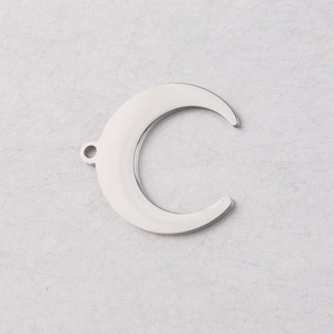 Macro shot of silver crescent moon charm in polished stainless steel for DIY jewelry making