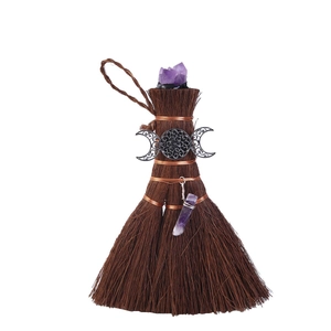 Close-up of Wicca mini broom with natural purple amethyst and triple moon symbol