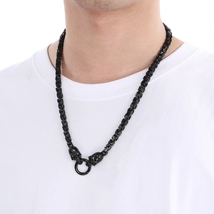 Close-up of black Byzantine chain necklace with skull pendant on a male model
