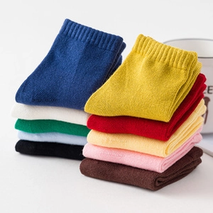 Detail view of colorful knitted cotton socks with ribbed cuffs and fine texture