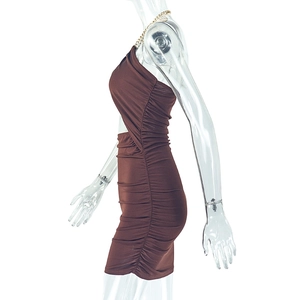 Detail of side ruching and golden chain neck strap on slim fit dark brown mini dress