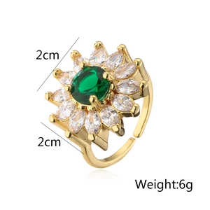 Detail view of flower-shaped 18K gold plated ring with green zircon and 2cm width