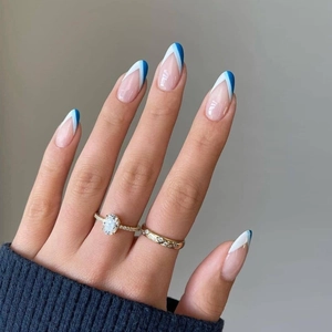 French almond press-on nails with blue and white geometric V-tips and gold rings