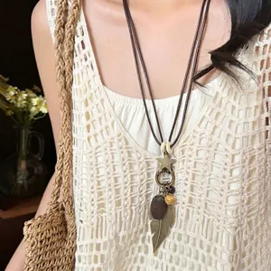 Bohemian vintage fringe necklace with bronze star and wood beads on cream lace top