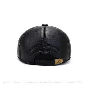 Close-up of black faux leather baseball cap rear with adjustable metal buckle and texture