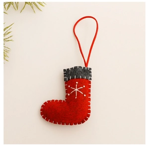 Close-up of red felt Christmas stocking with white snowflake embroidery and stitching