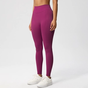 Close-up of seamless high-waist yoga pants in deep magenta with elastic compression fabric