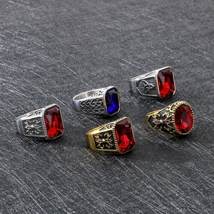 Macro detail of vintage Viking rings featuring large gemstones and baroque carvings