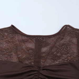 Detail of brown lace stitching with pleated texture on a slim fit long sleeve dress