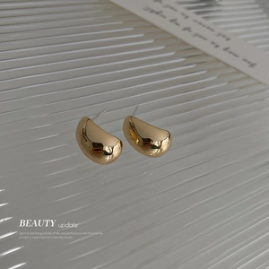Minimalist gold geometric C-shaped bean stud earrings with a polished mirror finish