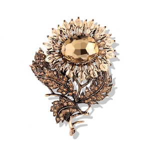 Vintage sunflower brooch with amber crystal and champagne rhinestones on a gold metal base