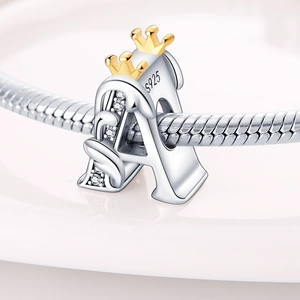 Macro shot of S925 silver letter A charm with golden crown and sparkling zircons