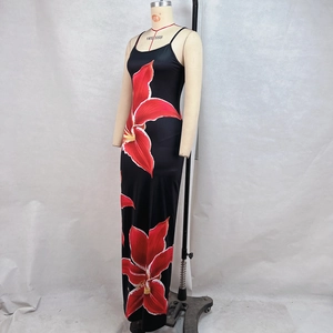 Detailed view of the red floral print on the sleek black bodycon maxi dress fabric