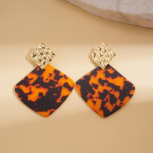 Vintage acrylic geometric earrings with golden textured metal and tortoise resin drop
