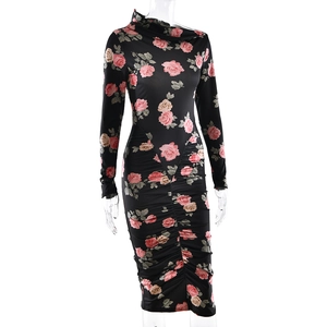 Close-up of black bodycon dress with pink rose floral print and ruched detailing