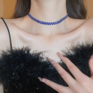 Detail of elegant dark blue rhinestone choker necklace on a model with luxurious finish