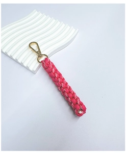 Close-up of pink and white handmade braided cord keychain with gold metal swivel clasp