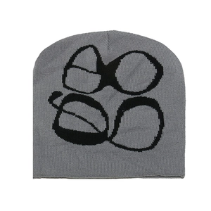Macro detail of Y2K knit beanie with black jacquard graphic on soft grey knitted fabric