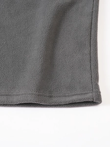 Close-up of gray fleece fabric texture showing detailed stitching and high-quality fibers