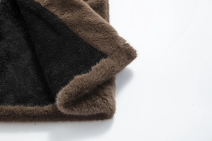 Detail of premium thick faux mink fur fabric with dual-tone black and dark brown fibers
