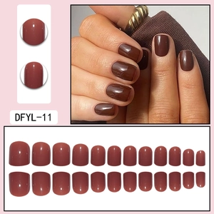 Detail of short square oval red-brown glossy press-on nails set including 24 pieces