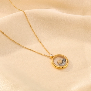 18K gold plated celestial necklace with sun moon and star charms in a round glass locket