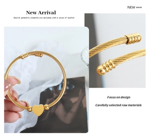 Macro view of gold plated heart cable bracelet showing intricate twisted metal texture