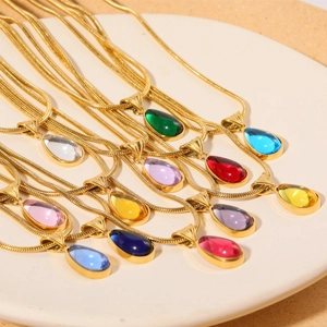 18K gold plated stainless steel teardrop pendant necklaces in multiple colors on a tray