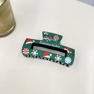 Green Christmas hair claw clip with snowflake and Santa hat motifs for women