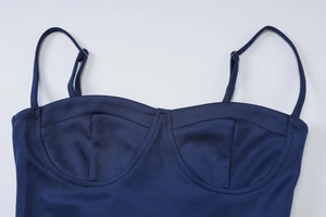 Detailed view of dark blue dress bodice featuring adjustable straps and stitched cup support
