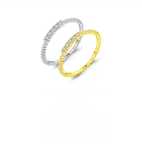 Detail of silver and gold S925 rings with bead texture and six sparkling zircons