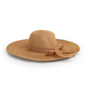 Macro detail of hand-woven straw sun hat texture featuring a decorative bow tie