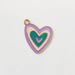 Macro shot of layered heart enamel pendant with purple and pink tones in gold plating