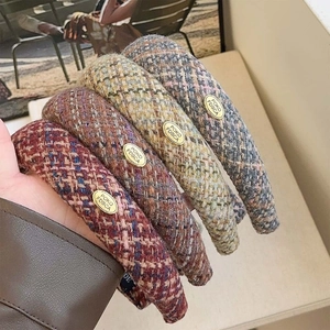 Chic plaid fabric headbands with gold labels in various autumn colors and textures